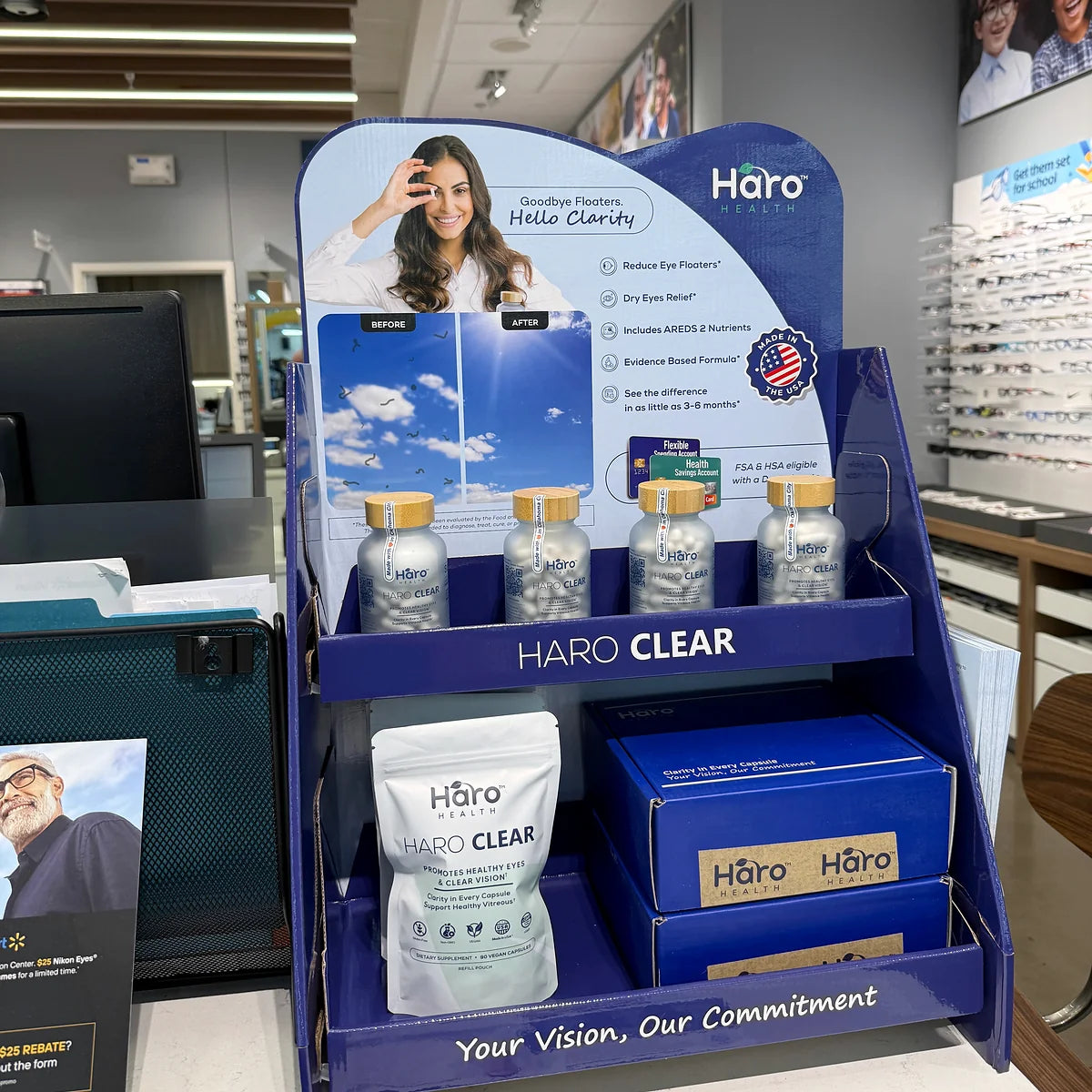 Haro Clear countertop display with bottles and refill pouches in an optical store