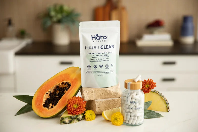 Haro Clear refill pouch and capsules with fruit on a kitchen counter